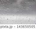 Water drops on transparent glass surface on a rainy day 143650505