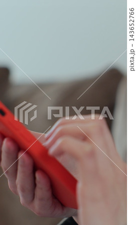 Vertical video. Close-up of young women hand. Hand of woman using texting mobile smartphone or chatting. Reading social media internet, typing text. 143652766