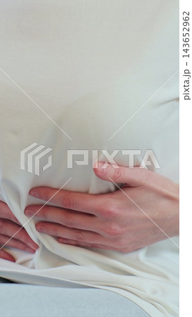 Vertical video. Woman feeling abdominal, ulcer in her tummy at home. Unrecognizable woman feels bad digestive problems abdominal pain. People health care. Vertical video. Woman feeling abdominal, ulcer in her tummy at home. Unrecognizable woman feels bad digestive problems abdominal pain. People health care. 143652962