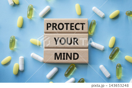 PROTECT YOUR MIND symbol. Concept words PROTECT YOUR MIND on wooden blocks. Beautiful blue background with pills. Healthcare and PROTECT YOUR MIND concept. Copy space. PROTECT YOUR MIND symbol. Concept words PROTECT YOUR MIND on wooden blocks. Beautiful blue background with pills. Healthcare and PROTECT YOUR MIND concept. Copy space. 143653248