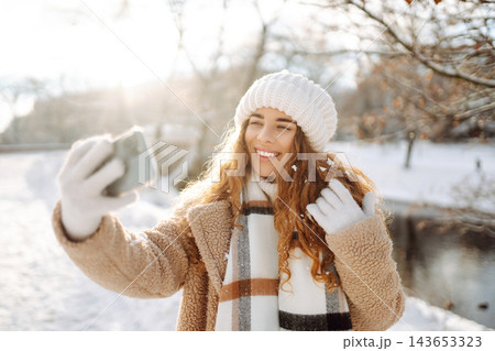 Beautiful female tourist with phone having fun outdoors. Travel concept. Beautiful female tourist with phone having fun outdoors. Travel concept. 143653323
