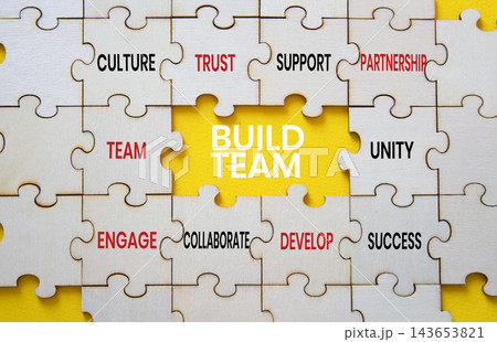 Build team symbol. Concept words build team on puzzle pieces. Team building and collaboration concept. Yellow background. Copy space. Build team symbol. Concept words build team on puzzle pieces. Team building and collaboration concept. Yellow background. Copy space. 143653821