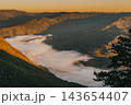 Golden Sunrise over Fog Filled Mountain Valley 143654407