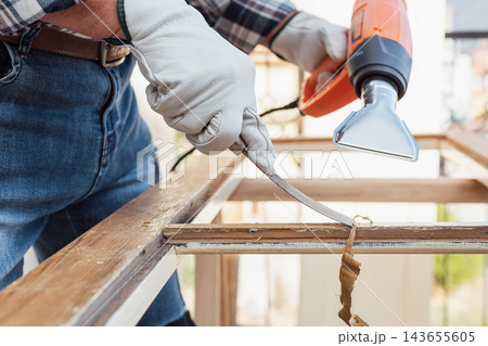 Carpenter at work, restoring an old wooden window. Carpentry. Carpenter at work, restoring an old wooden window. Carpentry. 143655605