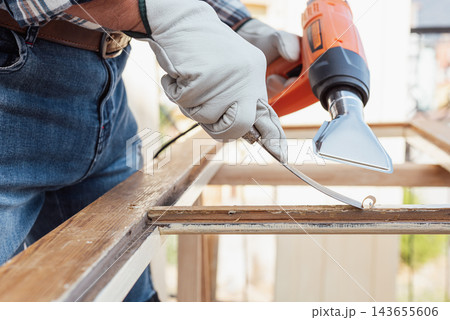Carpenter at work, restoring an old wooden window. Carpentry. Carpenter at work, restoring an old wooden window. Carpentry. 143655606