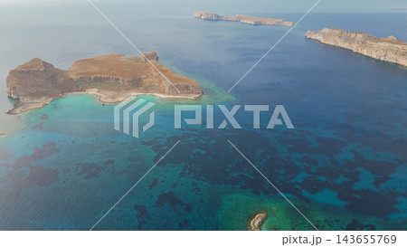High angle panoramic drone view of famous Balos beach lagoon with turquoise sea water and Gramvousa island cape on Crete island in Greece High angle panoramic drone view of famous Balos beach lagoon with turquoise sea water and Gramvousa island cape on Crete island in Greece 143655769