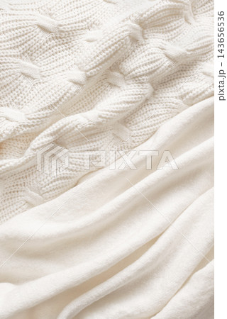 White knitted textiles, soft and warm woolen textures White knitted textiles, soft and warm woolen textures 143656536