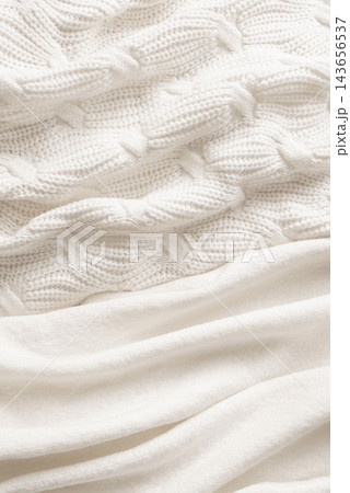 White knitted textiles, soft and warm woolen textures White knitted textiles, soft and warm woolen textures 143656537