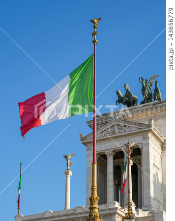Italian National Flag Waving at the Victor Emmanuel II Monument in Rome Against Clear Blue Sky 143656779