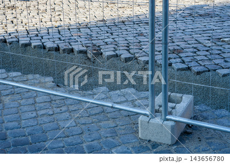 Historic Cobblestone Pavement Being Re-Laid at Higher Street Level During Urban Road Reconstruction 143656780
