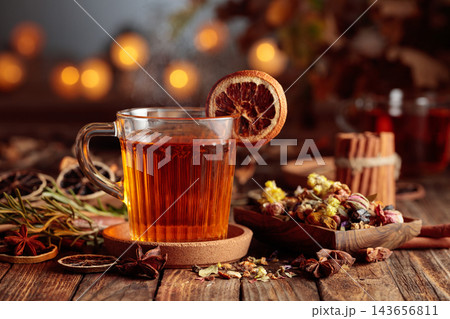 Autumn herbal tea with cinnamon, anise, and dried citrus slices. 143656811