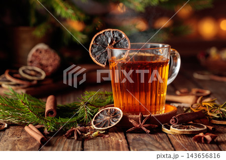 Christmas herbal tea with cinnamon, anise, and dried citrus slices. 143656816