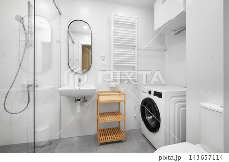 Modern bathroom interior mockup with washing machine, shower cabin, and sink. Modern bathroom interior mockup with washing machine, shower cabin, and sink. 143657114