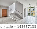 Modern apartment building staircase hall with elevator, wooden door, and panoramic window. 143657133