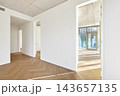 Modern empty apartment interior mockup with open layout, white walls, and bare concrete ceiling. 143657135