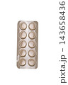 Blister pack containing ten round tablets in sealed pharmaceutical packaging isolated on a clean white background. 143658436