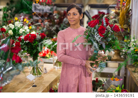 Portrait of a latin american woman choosing a bouquet of flowers Portrait of a latin american woman choosing a bouquet of flowers 143659191