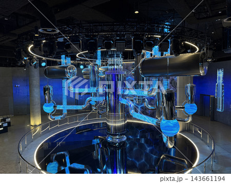Futuristic water-to-water power reactor features illuminated pipes and vibrant colors, illustrating a dynamic energy flow in a modern environment 143661194
