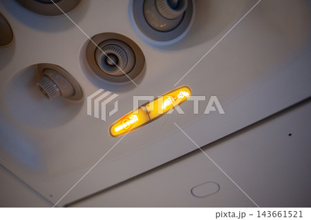 Ceiling light fixture features adjustable air vents and illuminated indicator lights, showcasing a modern design in an indoor environment Ceiling light fixture features adjustable air vents and illuminated indicator lights, showcasing a modern design in an indoor environment 143661521