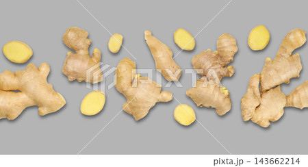 Fresh ginger roots arranged creatively on gray surface 143662214