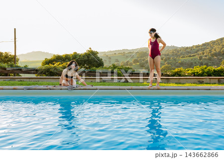 Two Children Playing Poolside at a Luxury Countryside Villa Swimming Pool Two Children Playing Poolside at a Luxury Countryside Villa Swimming Pool 143662866
