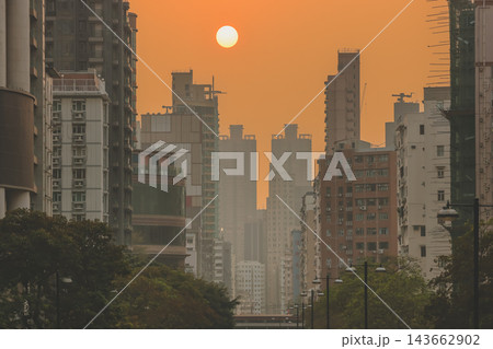 Hong Kong Oct 13 2026 Glowing Crimson Sun Setting Between High Rise Skyscrapers 143662902