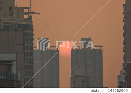 Hong Kong Oct 13 2026 Glowing Crimson Sun Setting Between High Rise Skyscrapers 143662906