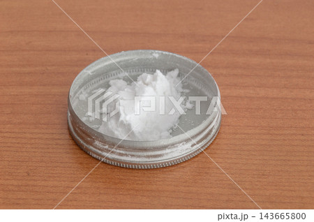 Close-up of a white powder in a metal cap. Close-up of a white powder in a metal cap. 143665800
