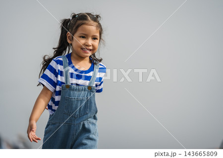 preschool child girl walking on a road on mountain in morning preschool child girl walking on a road on mountain in morning 143665809