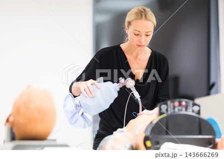Medical doctor specialist expert displaying method of patient intubation technique on hands on medical education training and workshop. Medical doctor specialist expert displaying method of patient intubation technique on hands on medical education training and workshop. 143666269