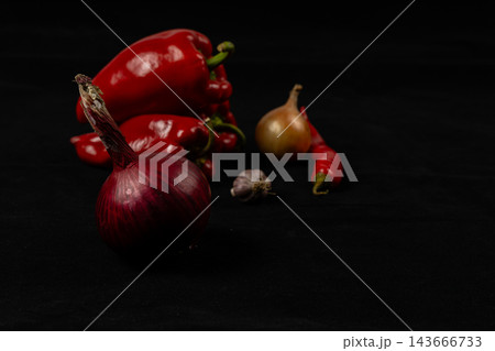 Pepper, chili, onion, and garlic arranged on a kitchen surface Pepper, chili, onion, and garlic arranged on a kitchen surface 143666733
