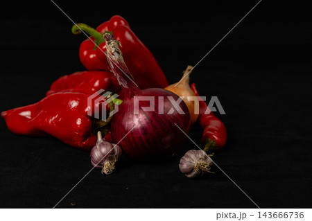Peppers, chili, onion, and garlic arranged on a kitchen surface Peppers, chili, onion, and garlic arranged on a kitchen surface 143666736