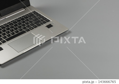 Modern laptop on a gray desk in an office workspace during the day Modern laptop on a gray desk in an office workspace during the day 143666765