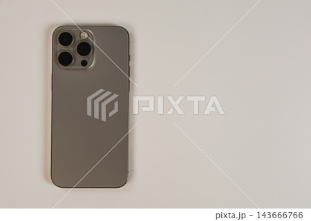 Modern smartphone placed on plain surface in office environment 143666766