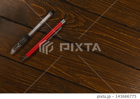Pens placed on a wooden desk in an office workspace 143666775
