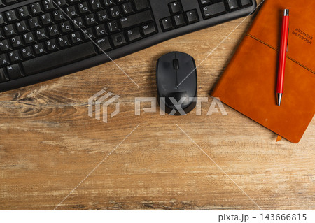 Working desk setup with keyboard, mouse, notebook, and pen Working desk setup with keyboard, mouse, notebook, and pen 143666815