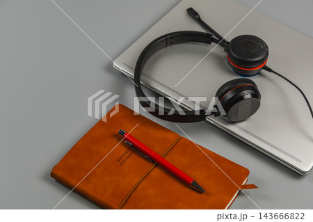 Workspace with laptop, notebook, pen, and headphones on a desk Workspace with laptop, notebook, pen, and headphones on a desk 143666822