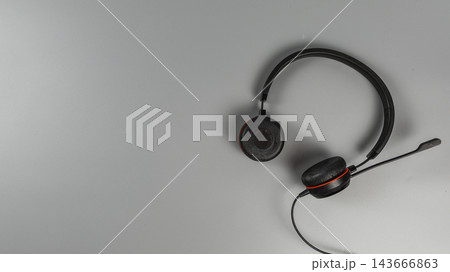 Headset placed on a flat surface in an office setting 143666863