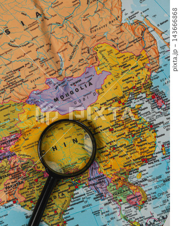 Exploring a world map with a magnifying glass for travel planning 143666868