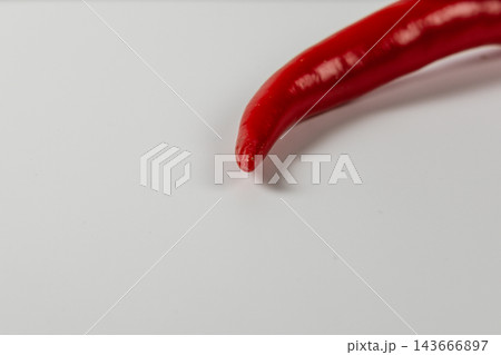 Red chili pepper on a white surface for cooking 143666897