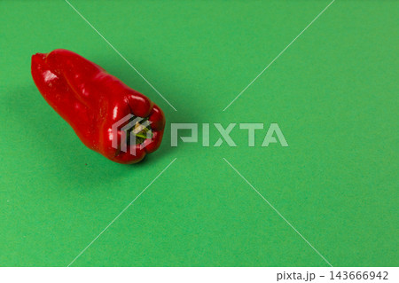 Red sweet pepper resting on a green surface Red sweet pepper resting on a green surface 143666942