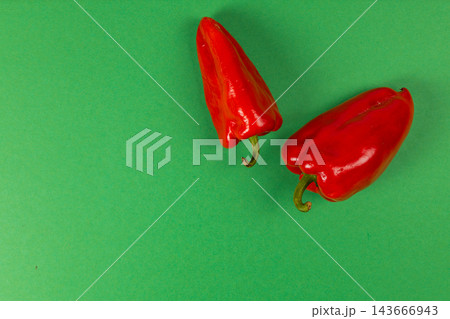 Red sweet peppers arranged on a green background for cooking Red sweet peppers arranged on a green background for cooking 143666943