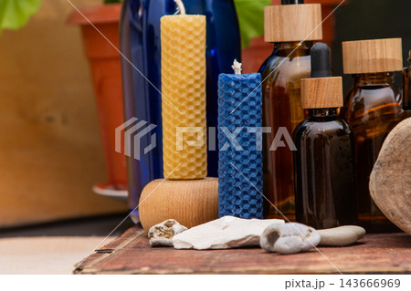 Beeswax Candle and Essential Oil Bottle. Aromatherapy Still Life with Candles and Bottles Beeswax Candle and Essential Oil Bottle. Aromatherapy Still Life with Candles and Bottles 143666969