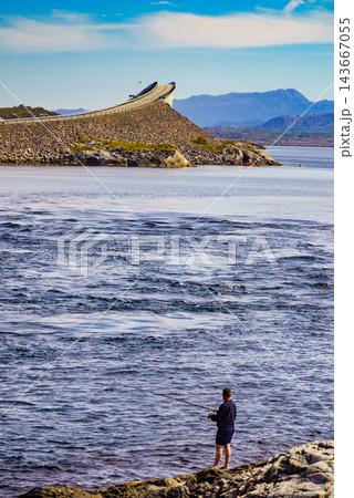 Angler with fishing rod on Atlantic road, Norway Angler with fishing rod on Atlantic road, Norway 143667055