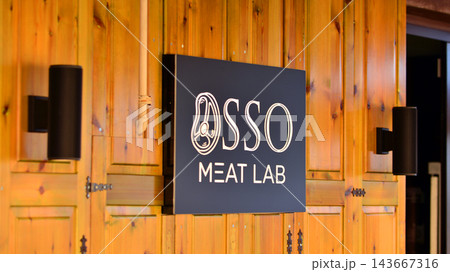Cefalu, Italy. 21 August 2026. Urban landscape. Neon sign with the inscription: Osso Meat Lab. Cefalu, Italy. 21 August 2026. Urban landscape. Neon sign with the inscription: Osso Meat Lab. 143667316