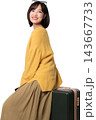 Happy smiling asian woman traveler sitting on luggage concept smart artificial intelligence travel planning assistant, cheerful female tourist enjoying journey preparation 143667733