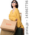 Cheerful asian woman holding sale shopping paper bag sitting with luggage representing modern retail experience powered by artificial intelligence technology 143667736