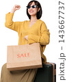 Cheerful asian woman holding sale shopping bag near suitcase generated with artificial intelligence concepts for travel retail experience 143667737