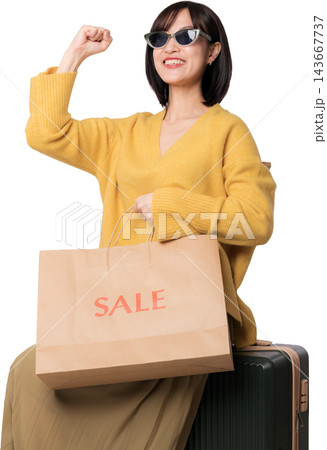 Cheerful asian woman holding sale shopping bag near suitcase generated with artificial intelligence concepts for travel retail experience Cheerful asian woman holding sale shopping bag near suitcase generated with artificial intelligence concepts for travel retail experience 143667737