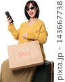Happy excited stylish asian woman holding smartphone shopping bag sitting on suitcase using artificial intelligence mobile application for online sale discount shopping with joy 143667738